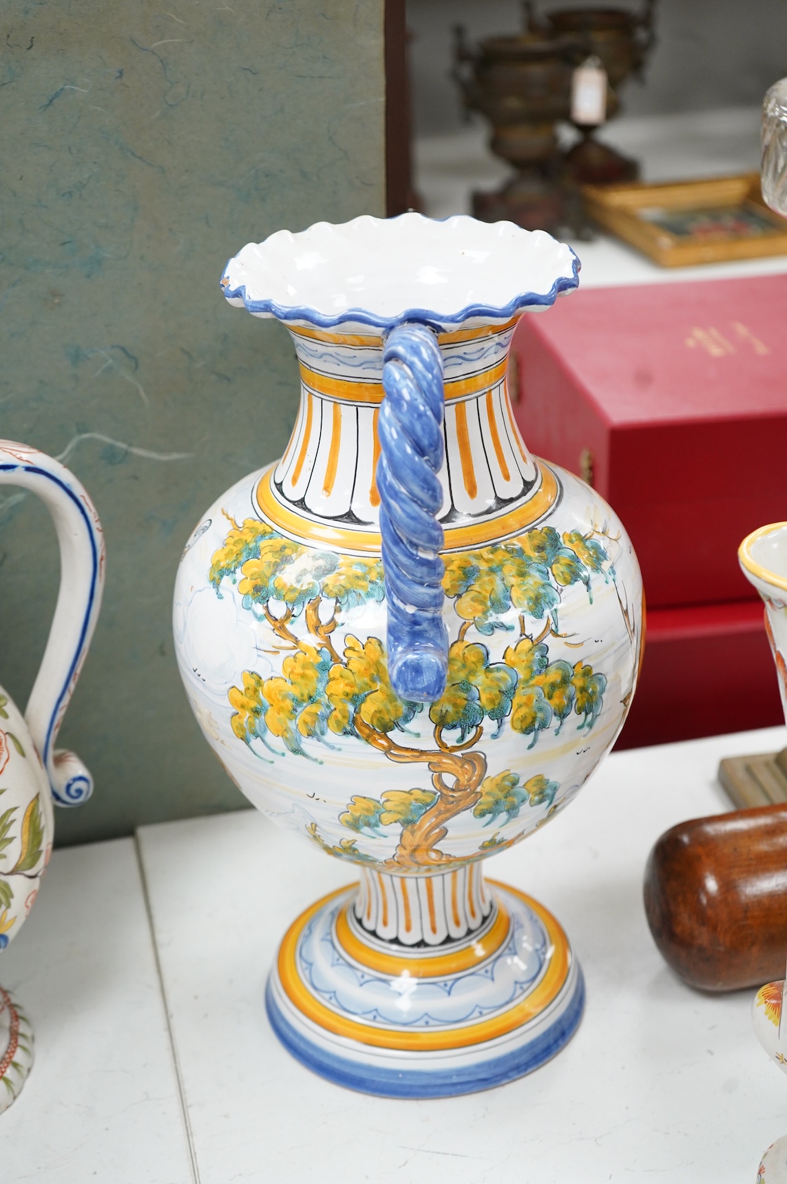 Two large French faience jugs and a vase, and a Talavera twin handled urn/vase, 44cm high